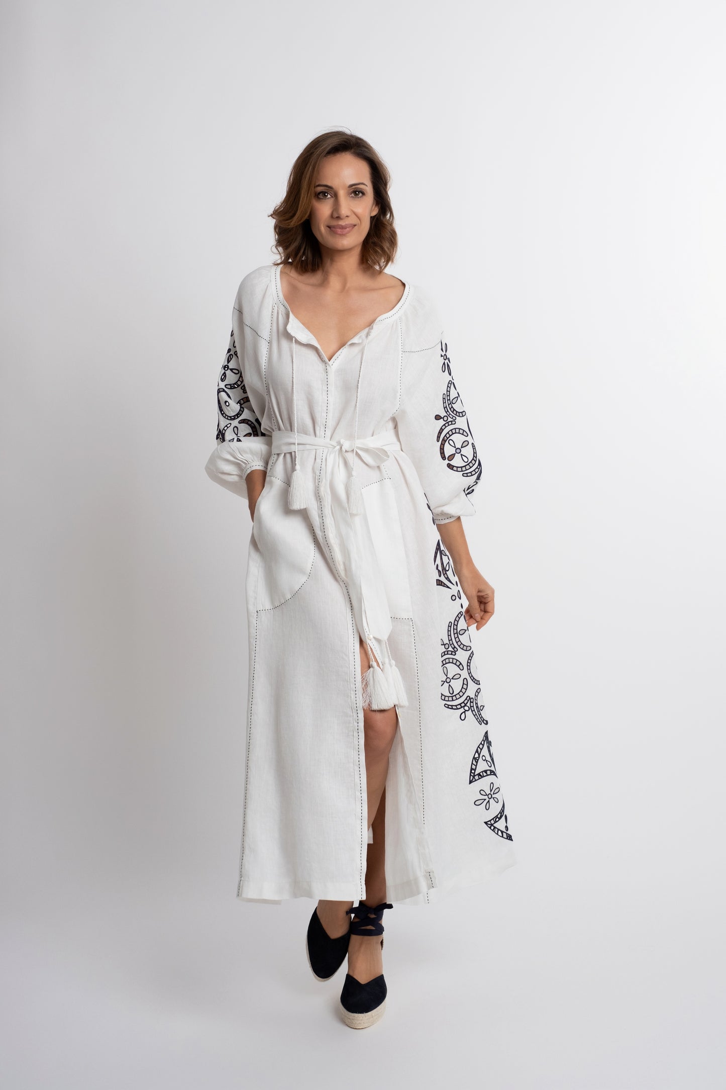 Santorini: White linen belted dress embroidered in navy with pompons and  mother of pearl buttons.