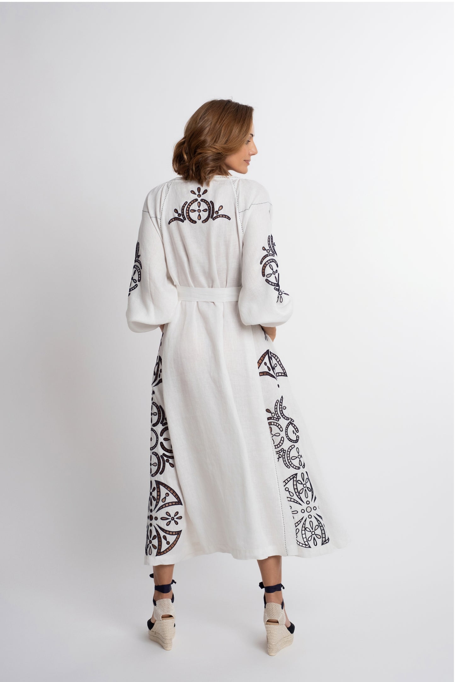 Santorini: White linen belted dress embroidered in navy with pompons and  mother of pearl buttons.
