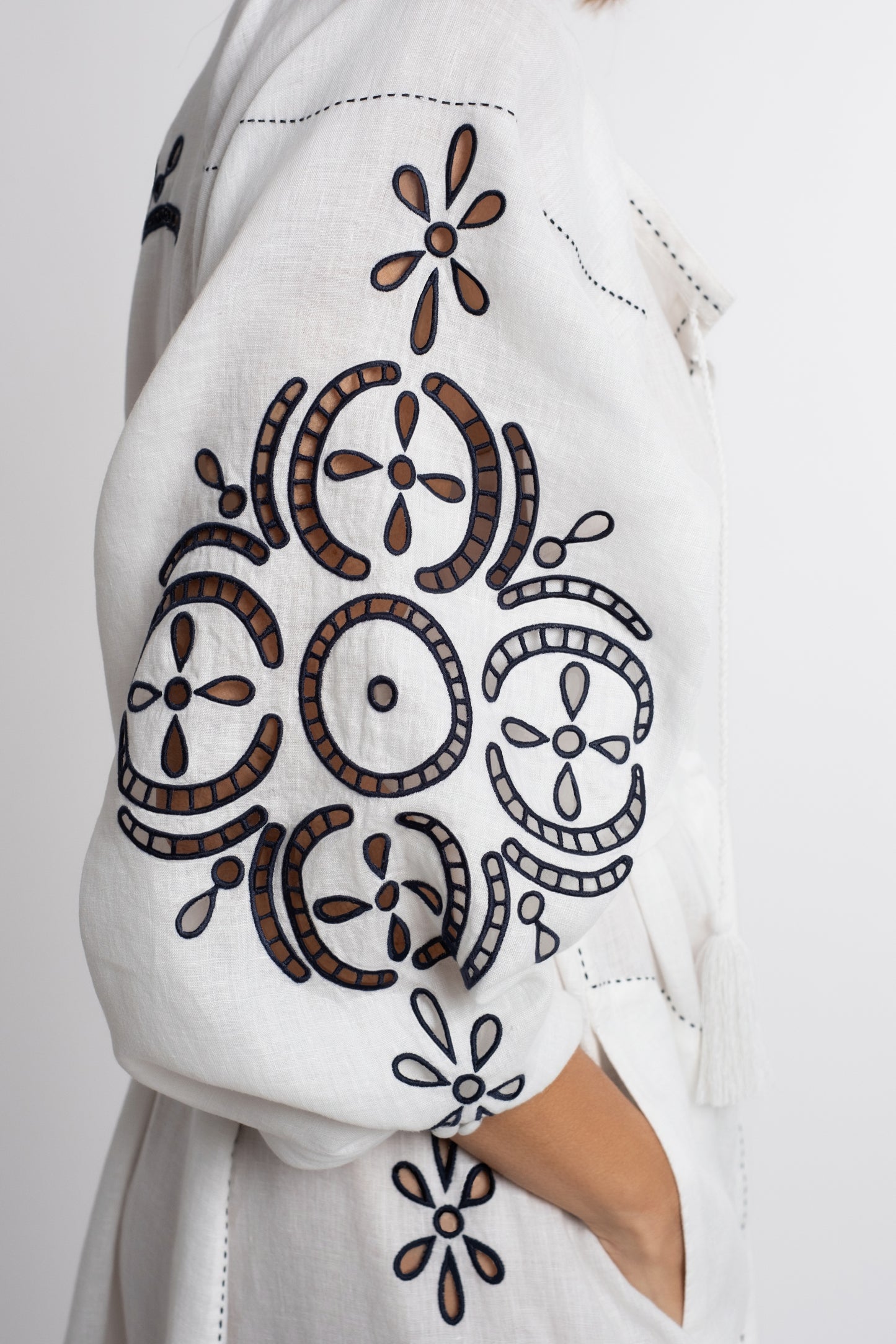 Santorini: White linen belted dress embroidered in navy with pompons and  mother of pearl buttons.