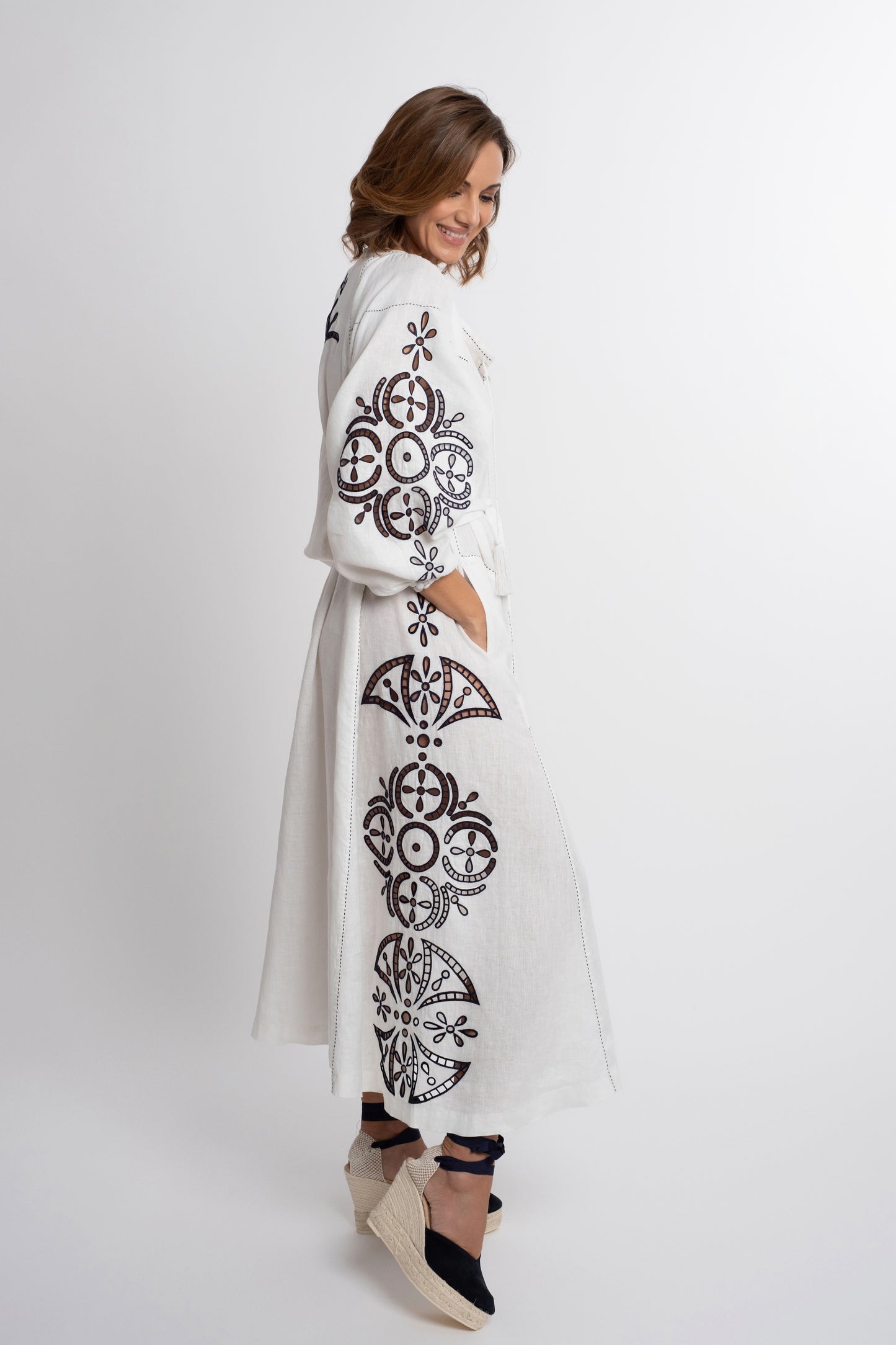 Santorini: White linen belted dress embroidered in navy with pompons and  mother of pearl buttons.