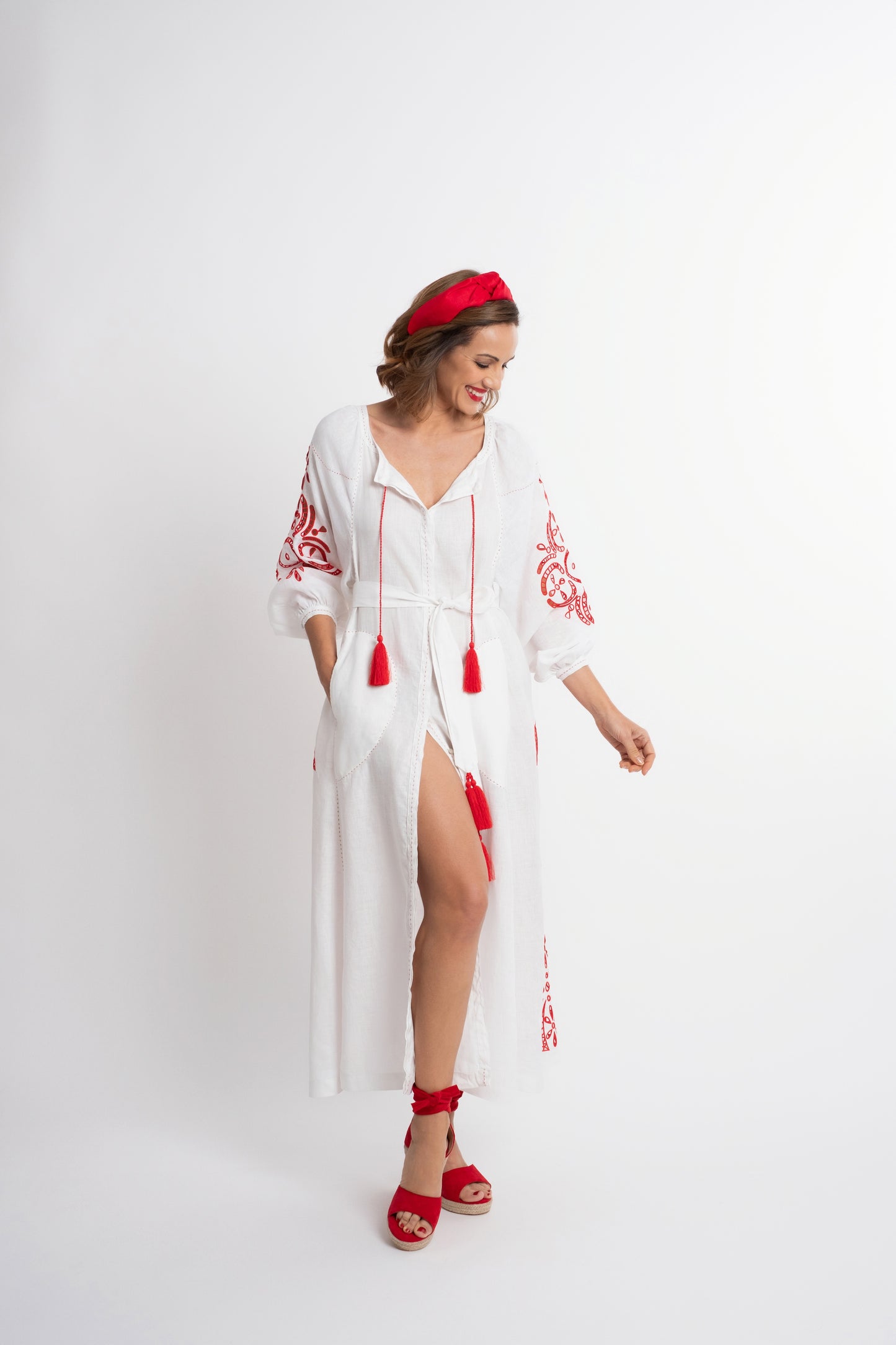 Santorini: White linen belted dress embroidered in red with pompons and  mother of pearl buttons.