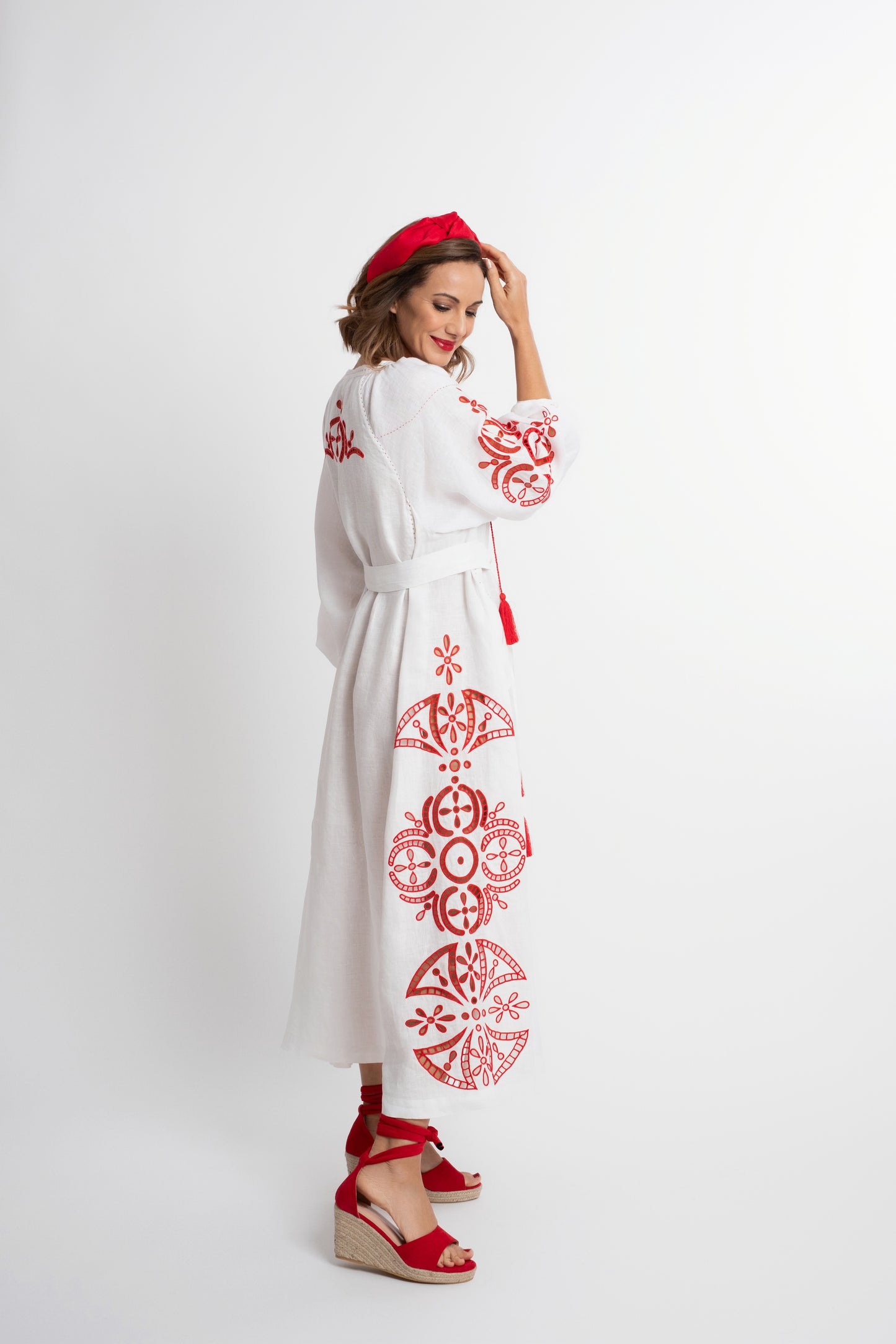Santorini: White linen belted dress embroidered in red with pompons and  mother of pearl buttons.