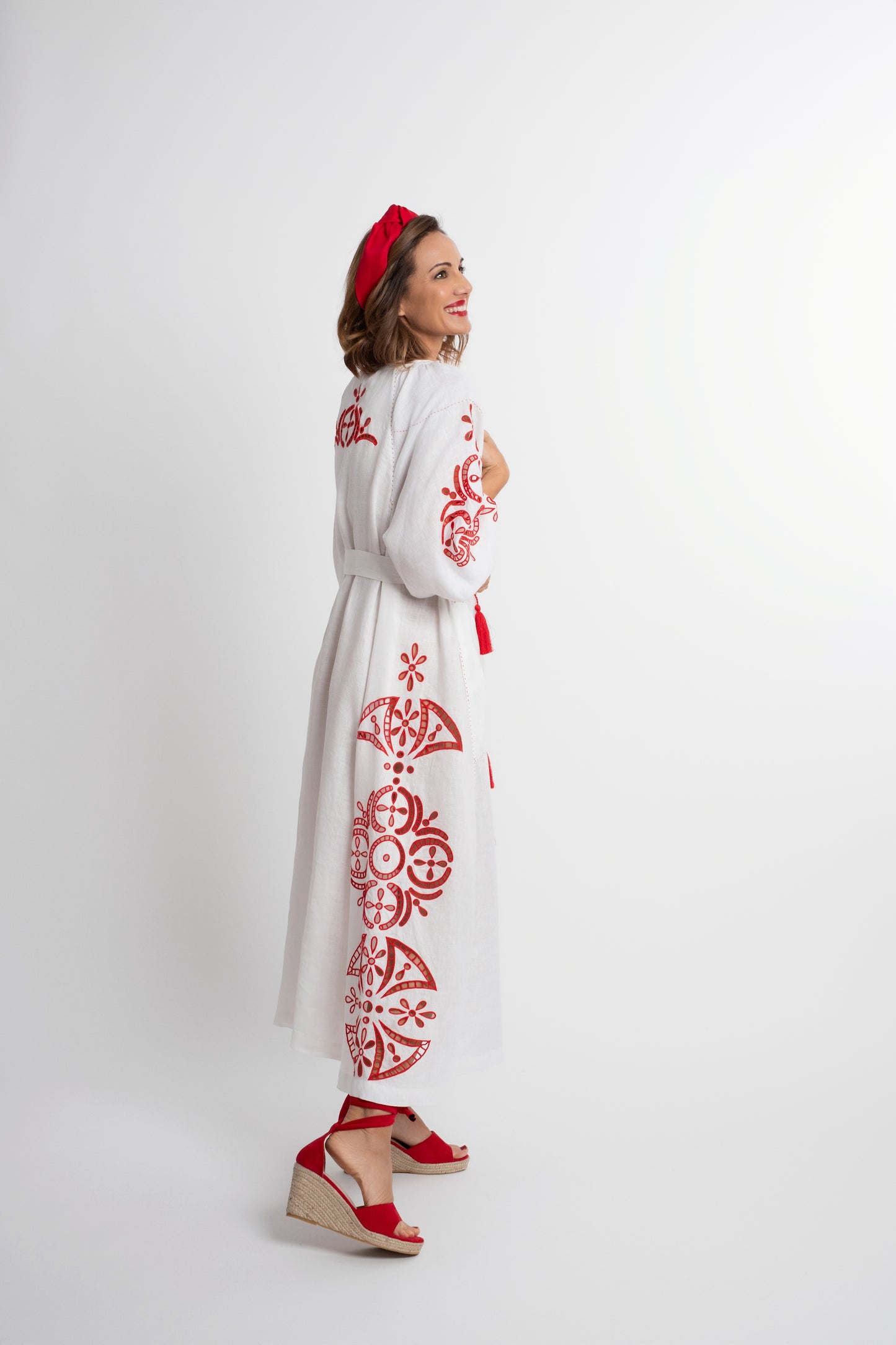 Santorini: White linen belted dress embroidered in red with pompons and  mother of pearl buttons.