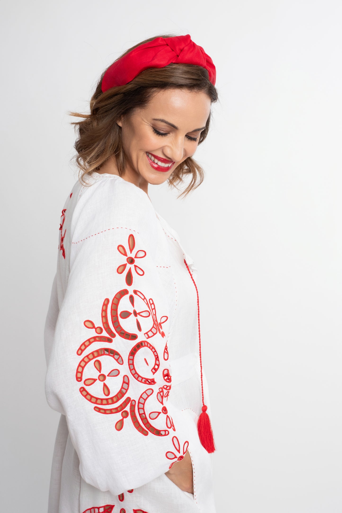 Santorini: White linen belted dress embroidered in red with pompons and  mother of pearl buttons.