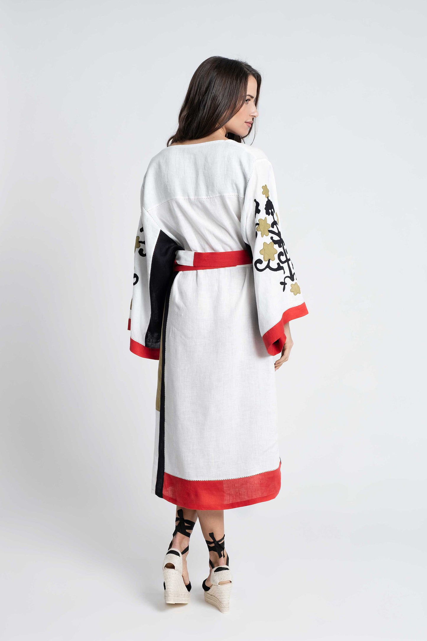 Bali: White linen belted dress embroidered in black, red and olive.
