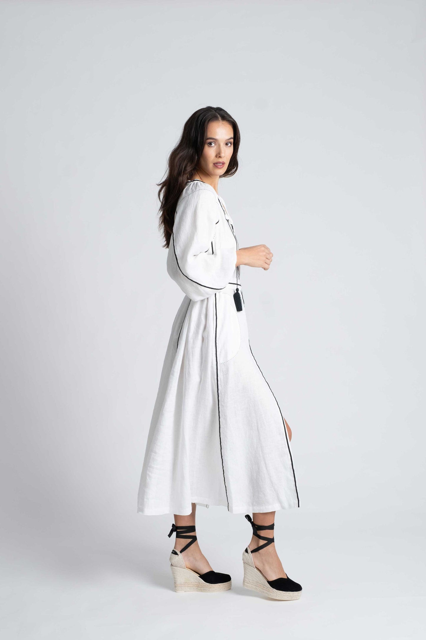 Fiji: White linen belted dress embroidered in black with pompons and  mother of pearl buttons.