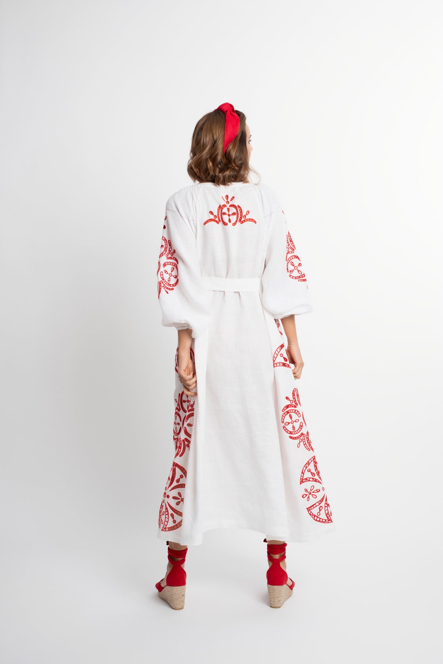 Santorini: White linen belted dress embroidered in red with pompons and  mother of pearl buttons.