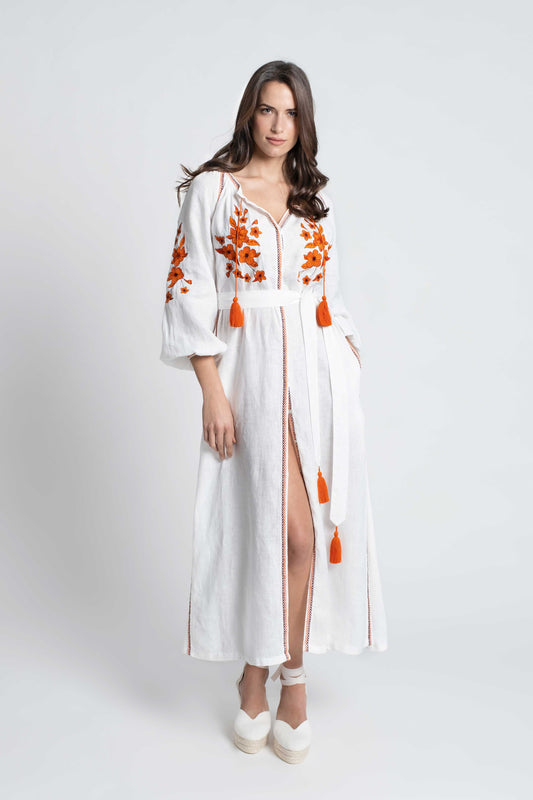 White linen belted dress embroidered in orange with pompons and  mother of pearl buttons.