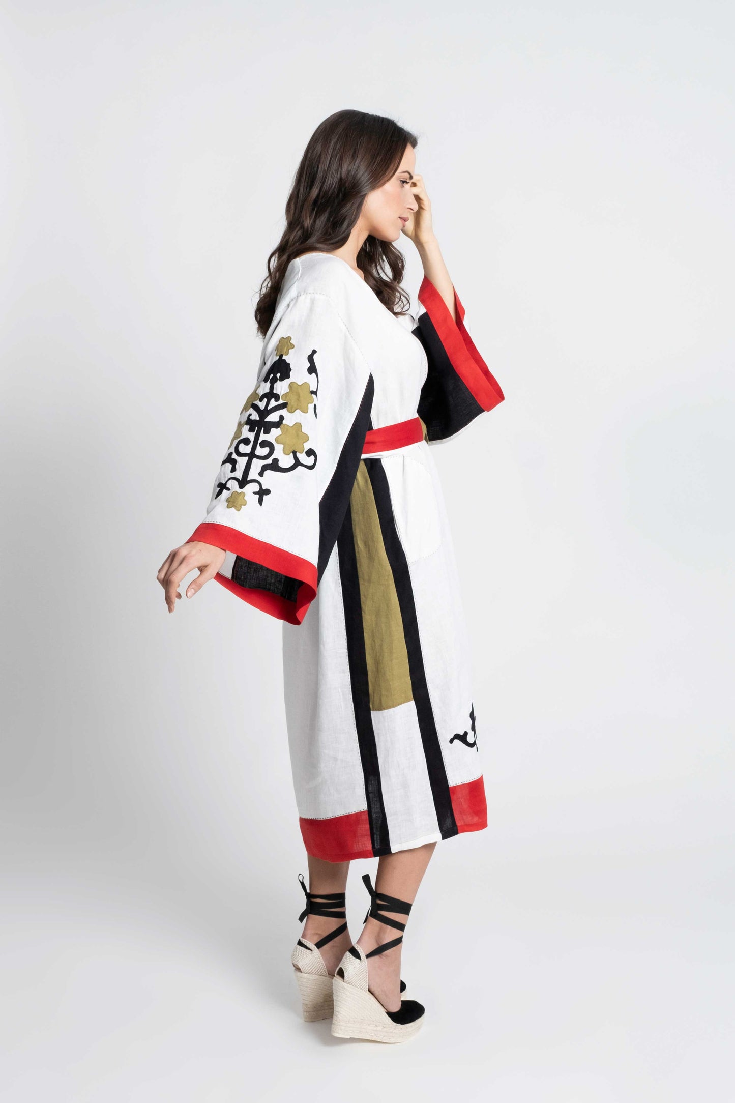 White linen belted dress embroidered in black, red and olive.