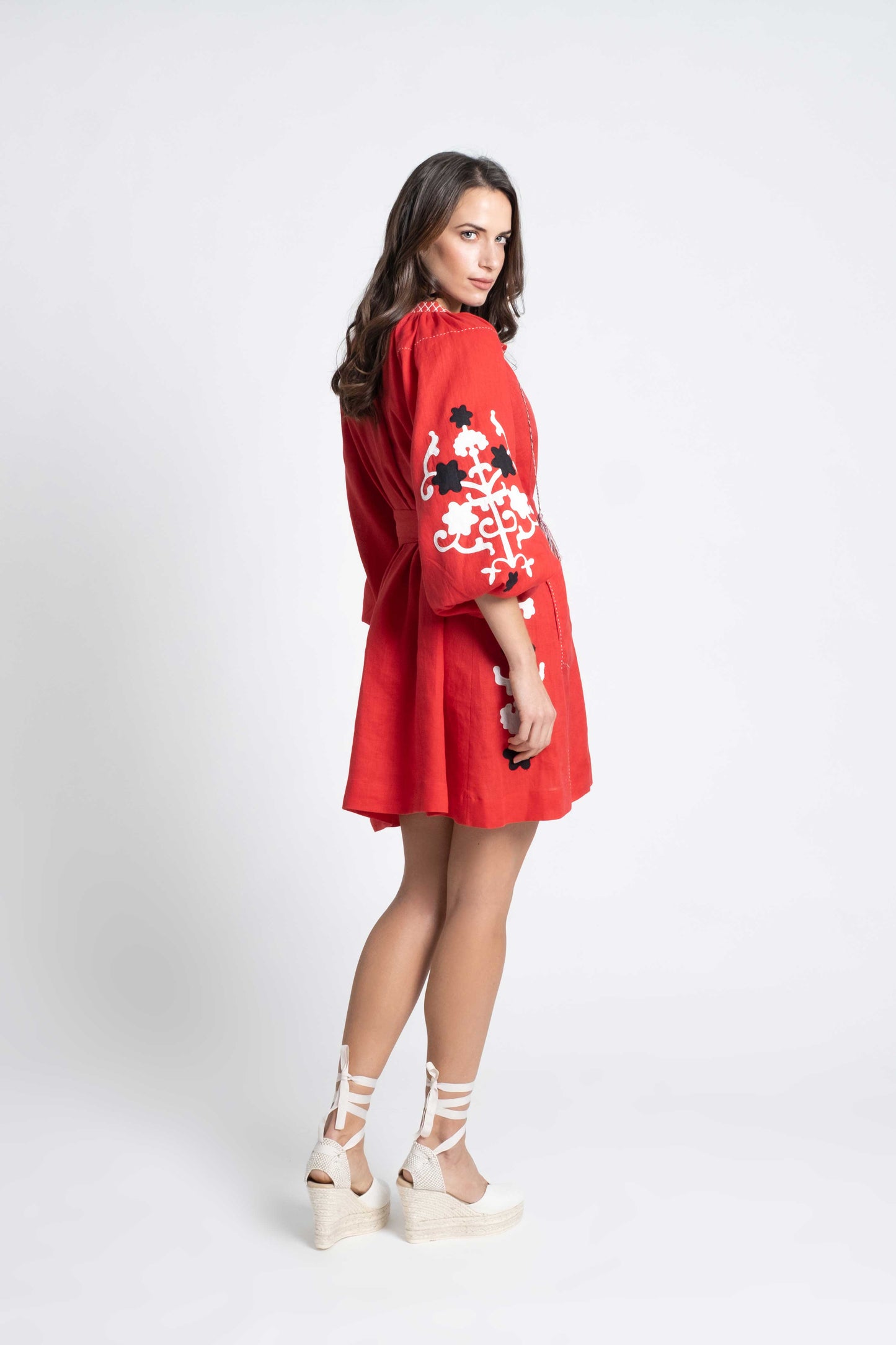 red linen belted short dress embroidered in black and white.