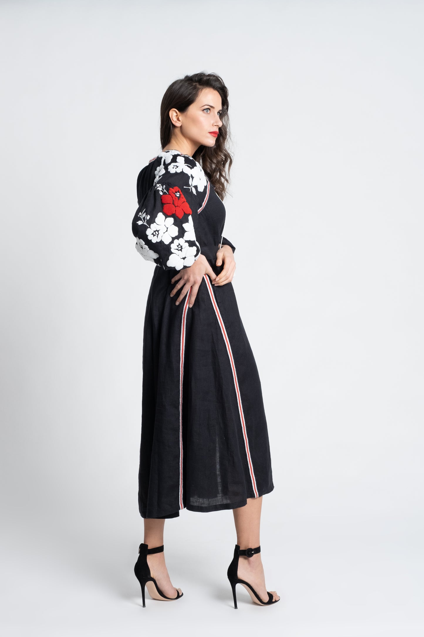 Black linen belted dress embroidered in white and red with pompons and  mother of pearl buttons.