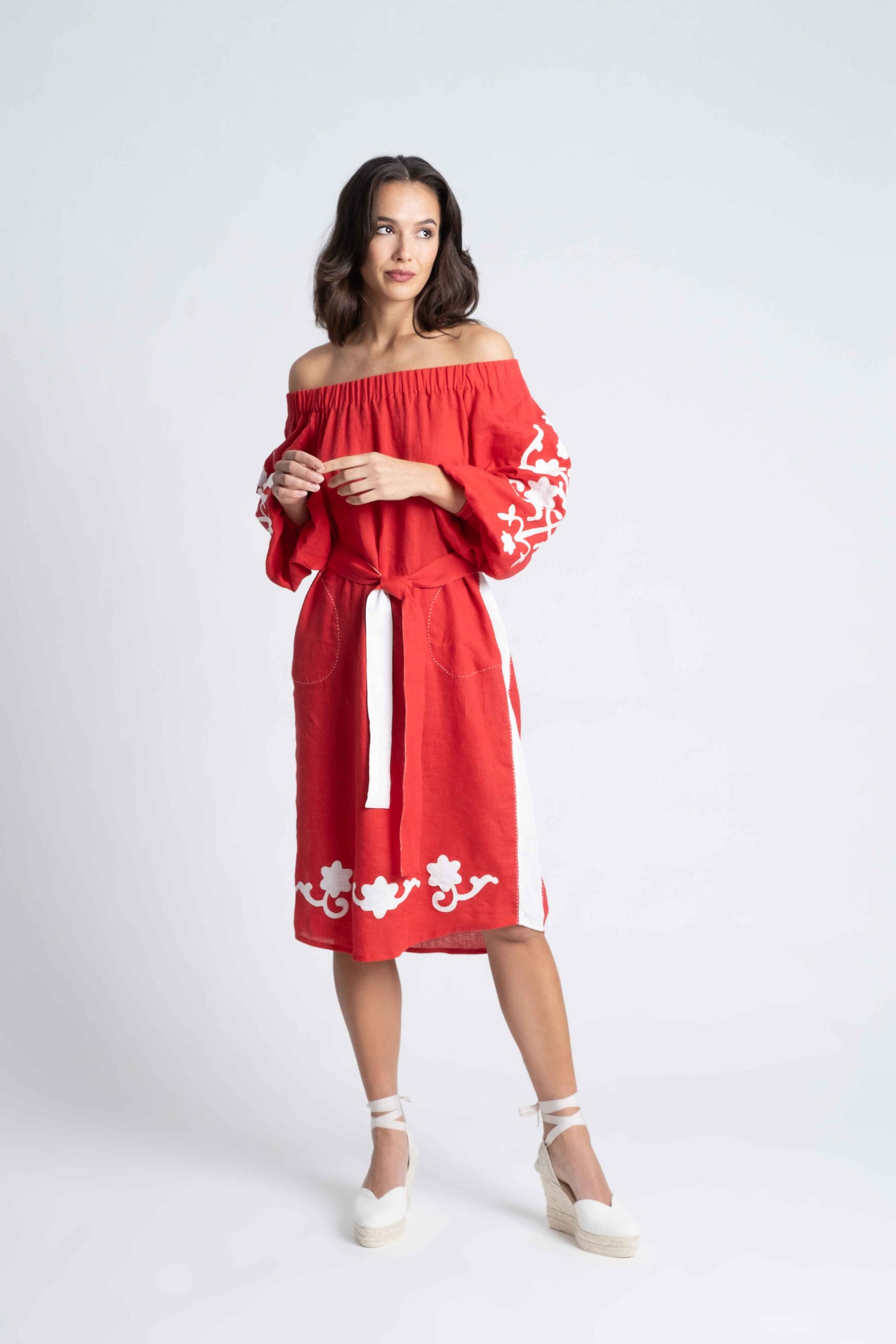 red linen belted dress embroidered in white.