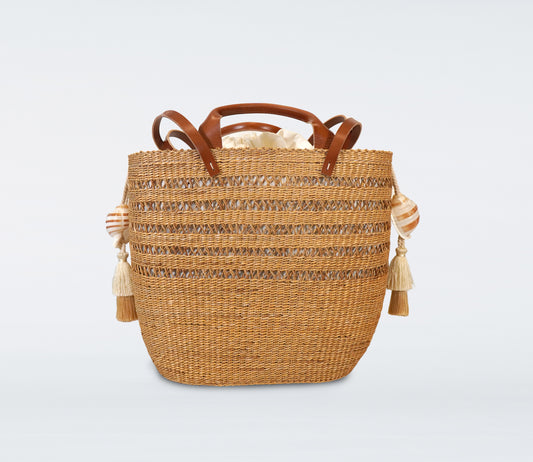 Milos: Large camel basket in straw, camel recycled leather handles, cotton bag and natural shells.
